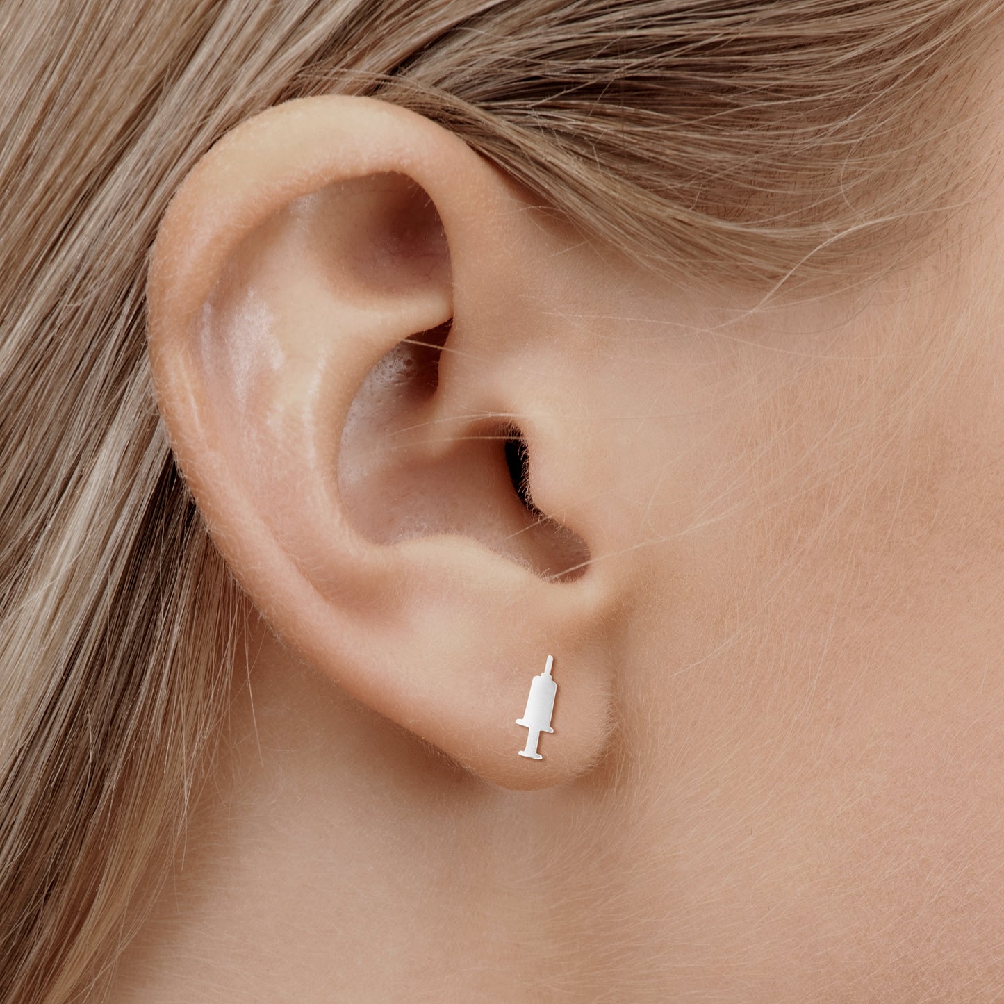 'IV Therapy Earrings' in silver on nurse model ear