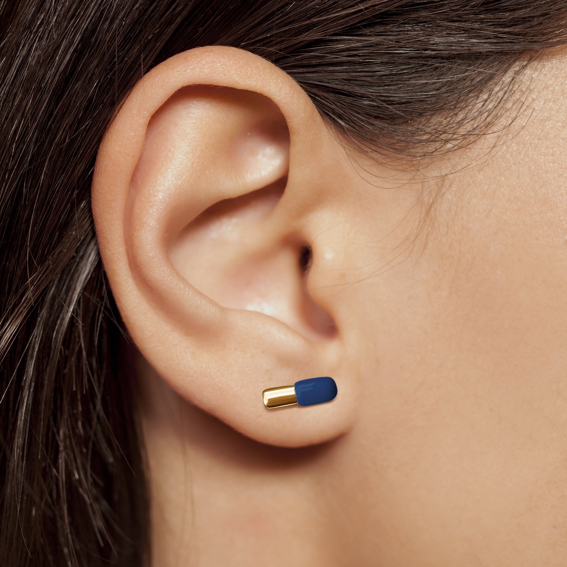 Pill earring in navy and rose gold in nurse model