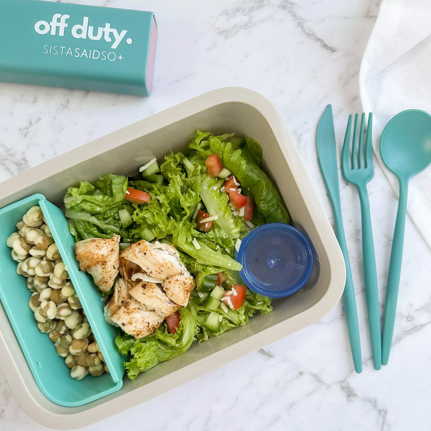 Reusable cutlery set in teal with chicken salad.