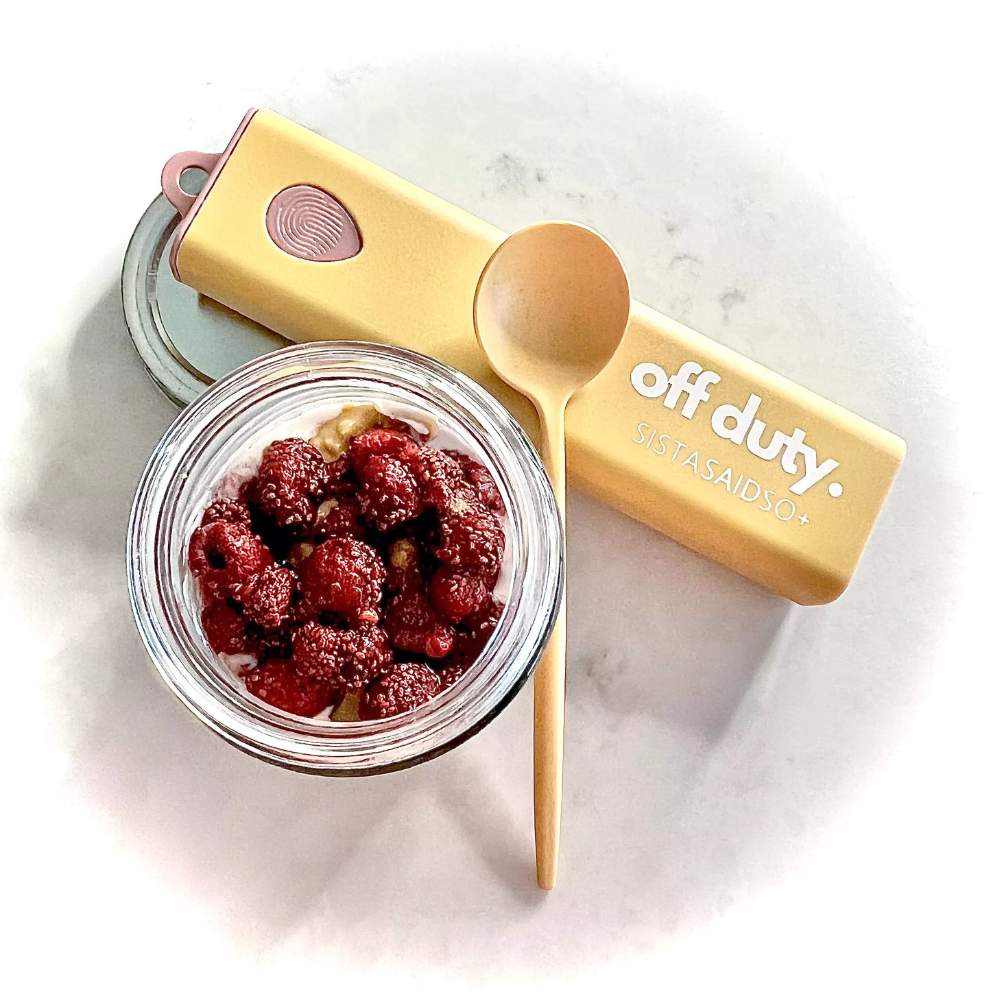 Reusable yellow spoon, featured with raspberry topped overnight oats.